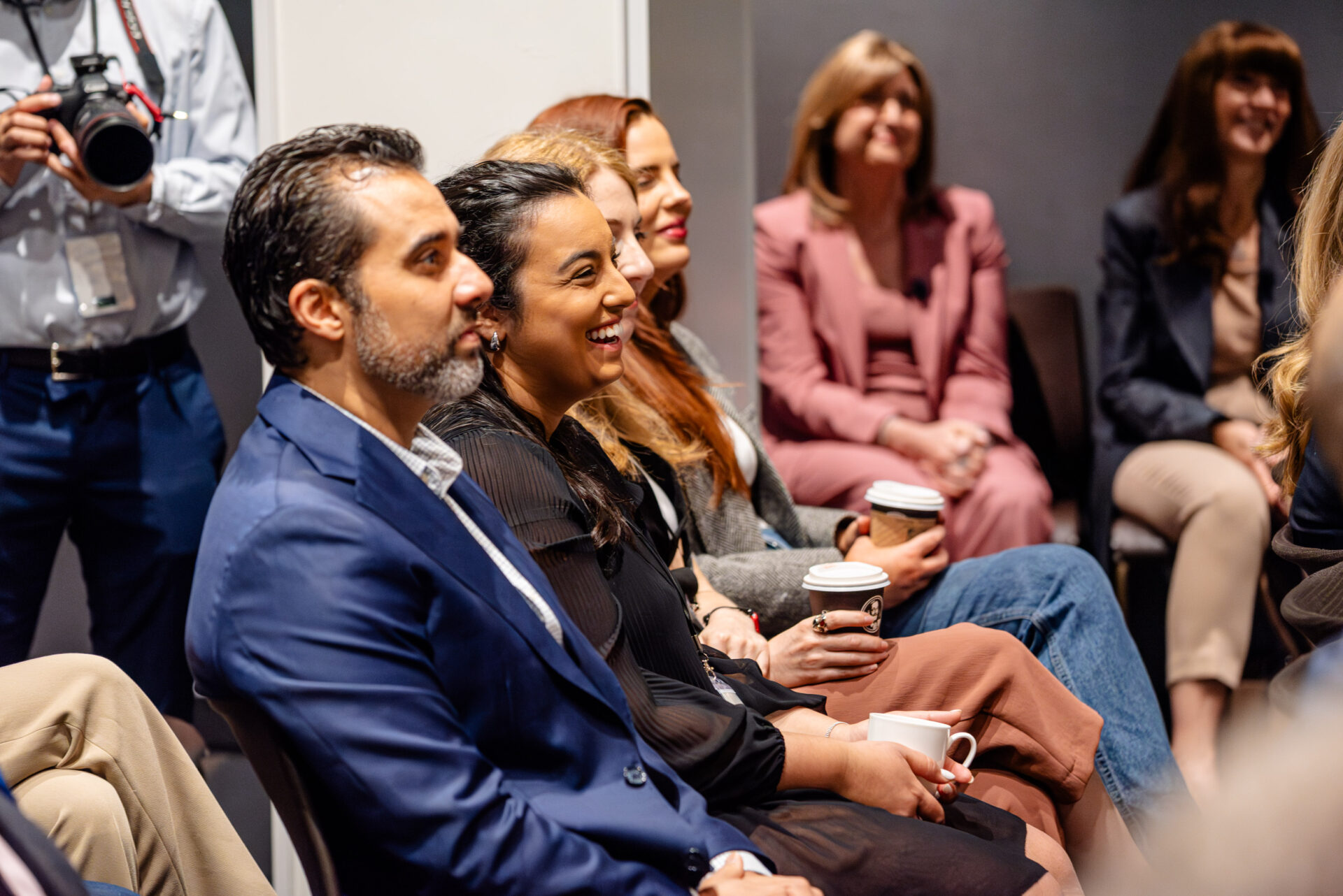 Audience smiling at the C-Suite Marketing Summit.